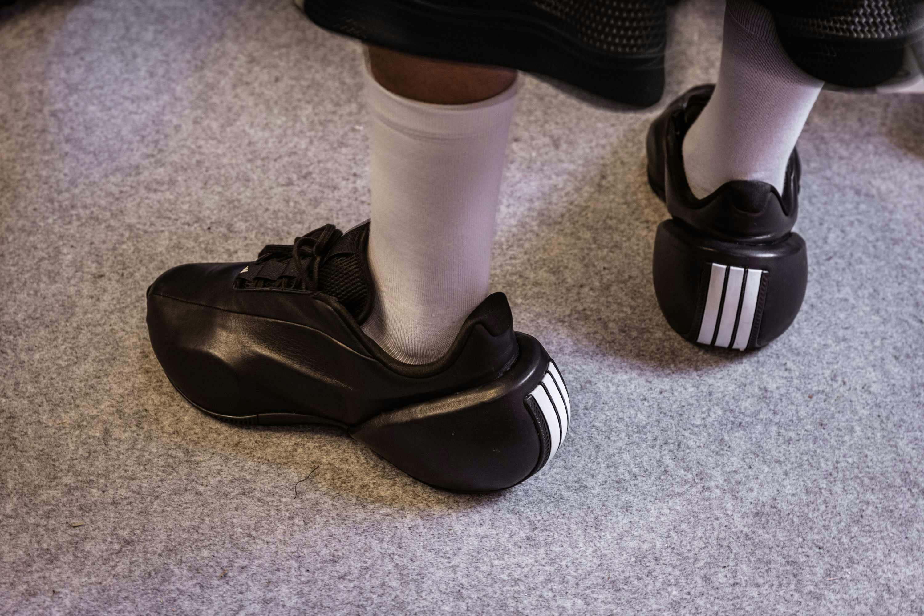 willy chavarria x adidas black leather sneaker with three white stripes on the heel from the fall/winter 2025 runway show